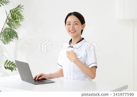 Woman in a white coat at a beauty clinic Woman in a white coat at a beauty clinic 141977590