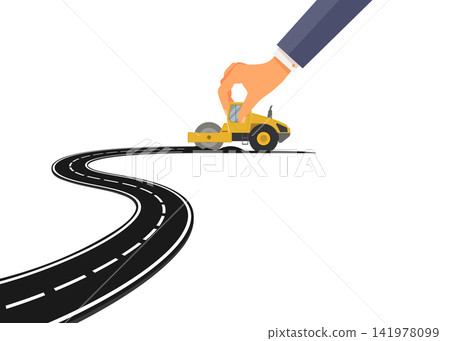hand holding toy road roller creating smooth asphalt winding path hand holding toy road roller creating smooth asphalt winding path 141978099