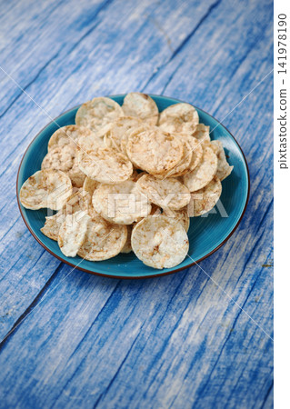 Crispy snacks served on a blue plate 141978190