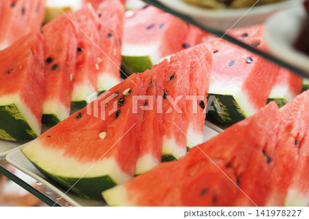 Sliced watermelon arranged neatly on a display tray Sliced watermelon arranged neatly on a display tray 141978227