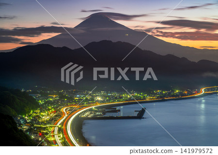 Mount Fuji and the trails of light from the highway, as seen from Satta Pass before dawn. 141979572