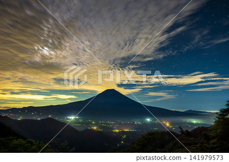 The night sky and Mount Fuji in summer, as seen from the forest road. The night sky and Mount Fuji in summer, as seen from the forest road. 141979573