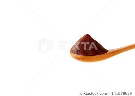 Smooth red bean paste served on a wooden spoon against a white background. Smooth red bean paste served on a wooden spoon against a white background. 141979639