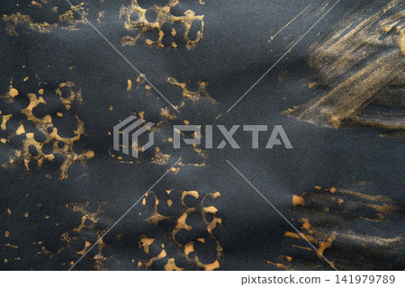Black Paper Showing Gold Paint Smears And Irregular Leopard Stencil Marks On Textured Dark Black Paper Showing Gold Paint Smears And Irregular Leopard Stencil Marks On Textured Dark 141979789