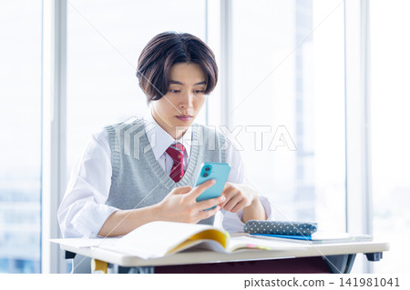 High school student studying on a smartphone. Filming cooperation: Denpa Gakuen Tokyo Electronics College. 141981041