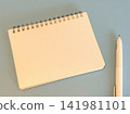 A blank ring notebook and a white pen 141981101