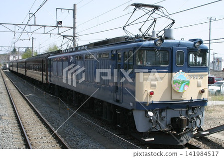 A passenger train pulled by EF64-36 locomotive and a railway landscape. A passenger train pulled by EF64-36 locomotive and a railway landscape. 141984517