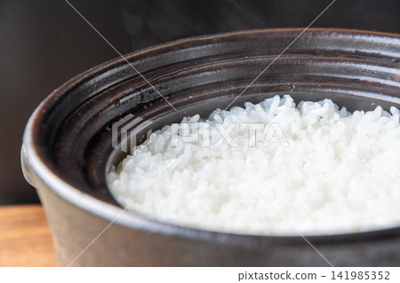 Shiny, freshly cooked rice in an earthenware pot Shiny, freshly cooked rice in an earthenware pot 141985352