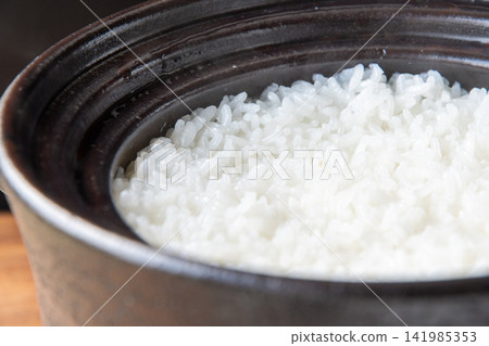Shiny, freshly cooked rice in an earthenware pot Shiny, freshly cooked rice in an earthenware pot 141985353