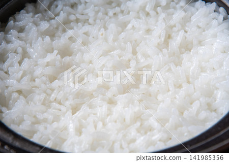 Shiny, freshly cooked rice in an earthenware pot Shiny, freshly cooked rice in an earthenware pot 141985356
