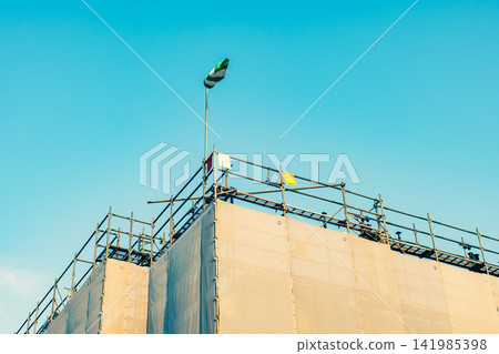 Windsocks and protective screens at a new construction site under construction a-3 Warm and cool color emphasis Windsocks and protective screens at a new construction site under construction a-3 Warm and cool color emphasis 141985398