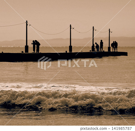 Couples enjoying time at a pier famous on social media. Couples enjoying time at a pier famous on social media. 141985787