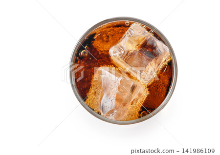 Top down view of cold carbonated soda with two ice cubes in glass isolated Top down view of cold carbonated soda with two ice cubes in glass isolated 141986109
