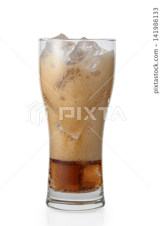 Tall glass of refreshing cola with heavy foam head and ice cubes Tall glass of refreshing cola with heavy foam head and ice cubes 141986133