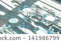 A city cafe terrace bathed in dappled sunlight filtering through the trees 141986799