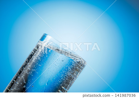 Clear drinking carbonated water in a tall glass. 141987036