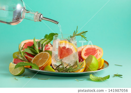 Cocktail with ice, citrus, rosemary and mint. Cocktail with ice, citrus, rosemary and mint. 141987056