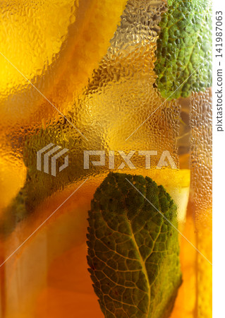 Iced tea in a misted glass. Macro shot. Iced tea in a misted glass. Macro shot. 141987063