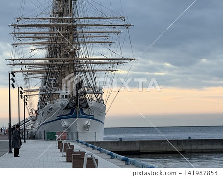 Kobe Port at dawn and a sailing ship at anchor Kobe Port at dawn and a sailing ship at anchor 141987853