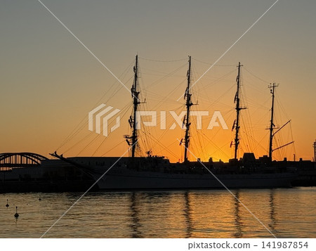 Kobe Port at dawn and a sailing ship at anchor Kobe Port at dawn and a sailing ship at anchor 141987854