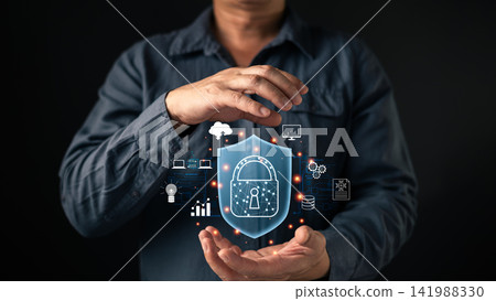 Man hands holding shield padlock hologram with cloud and network icons. Cybersecurity concept for data protection, privacy safety, digital defense, and secure internet technology system. 141988330