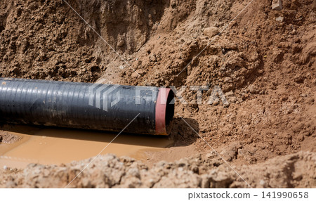 Underground pipe laying process in excavated ground trench. Underground pipe laying process in excavated ground trench. 141990658