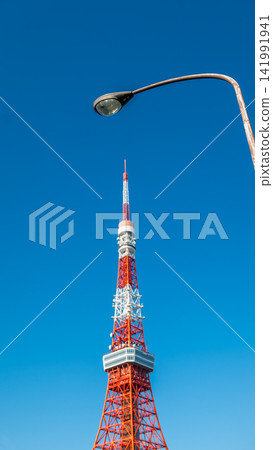Tokyo Tower Standing Tall Against Clear Blue Sky in Japan Tokyo Tower Standing Tall Against Clear Blue Sky in Japan 141991941