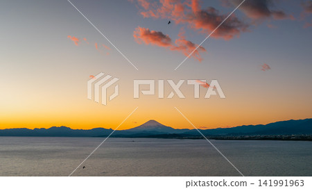 Mount Fuji at sunset over Sagami Bay in Kanagawa, Japan Mount Fuji at sunset over Sagami Bay in Kanagawa, Japan 141991963