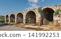 Ancient arched stone outer wall of the Stadium in the archaeological site of Perge, Antalya, Turkey 141992253