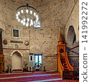 Interior of the historical Yivli Minare Mosque featuring the minbar and stone architecture in Antalya, Turkey 141992272
