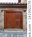 Ornate wooden door with hand carved pomegranate motifs in the historic Kaleici district of Antalya, Turkey 141992276