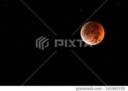 The moon glowing a coppery red during a total lunar eclipse, and the starry sky. The moon glowing a coppery red during a total lunar eclipse, and the starry sky. 141992330