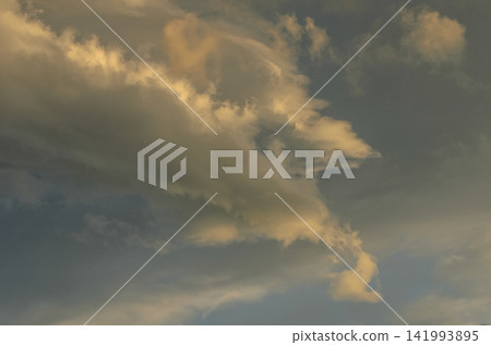 Mysterious clouds dance across the evening sky, painting a canvas of soft colors and enchanting shapes Mysterious clouds dance across the evening sky, painting a canvas of soft colors and enchanting shapes 141993895
