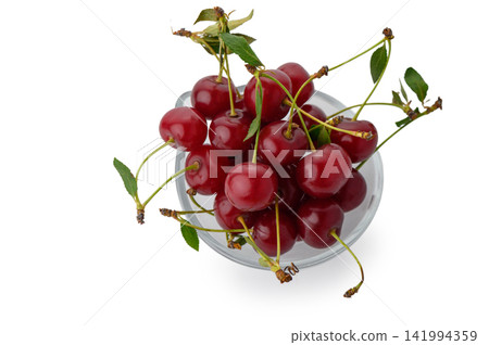 Top view of fresh ripe red cherries with stems and leaves in a glass bowl Top view of fresh ripe red cherries with stems and leaves in a glass bowl 141994359