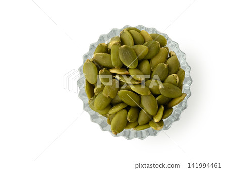 Overhead View of Faceted Glass Bowl with Shelled Green Pumpkin Seeds Overhead View of Faceted Glass Bowl with Shelled Green Pumpkin Seeds 141994461