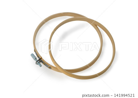 Crafting beauty with wooden embroidery hoops in a cozy workshop filled with the scent of fresh fabric and creativity Crafting beauty with wooden embroidery hoops in a cozy workshop filled with the scent of fresh fabric and creativity 141994521