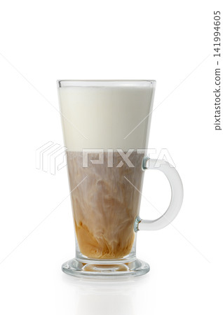 Tall glass mug with layered latte macchiato and dense milk foam on white background Tall glass mug with layered latte macchiato and dense milk foam on white background 141994605