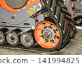 Heavy machinery tracks on a construction site during daytime hours 141994825