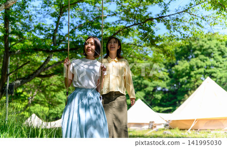 Swings and tents in the park Swings and tents in the park 141995030