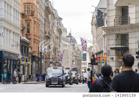 The streets of London with the Union Jack fluttering in the wind. The streets of London with the Union Jack fluttering in the wind. 141995139