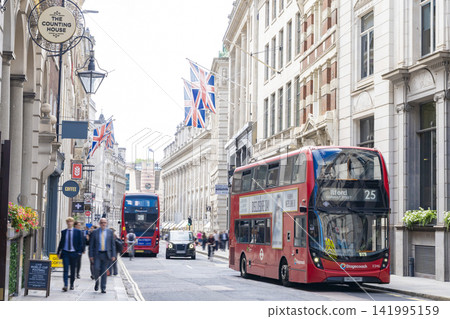 A red double-decker bus running through Cornhill in London A red double-decker bus running through Cornhill in London 141995159