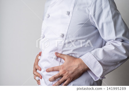 The chef puts his hand on his stomach. The chef puts his hand on his stomach. 141995289