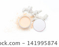 White powder spills from a round container. Skeletal coral rests beside the jar. Clean minimal scene on a bright surface. Ideal for beauty, skincare, or wellness themes 141995874