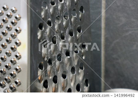 Close-Up of Metal Grater Textures for Kitchen and Cooking Concepts Close-Up of Metal Grater Textures for Kitchen and Cooking Concepts 141996492