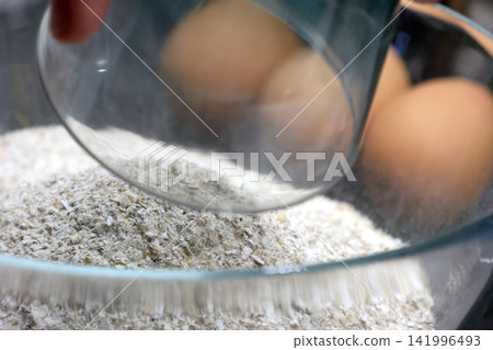 Baking Preparation with Fresh Eggs and Flour in a Glass Bowl Culinary Essentials Baking Preparation with Fresh Eggs and Flour in a Glass Bowl Culinary Essentials 141996493