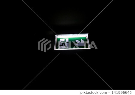 Emergency Exit Sign Illuminated in Darkness for Safety and Guidance Emergency Exit Sign Illuminated in Darkness for Safety and Guidance 141996645