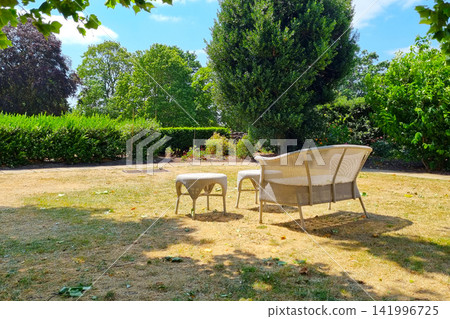 Peaceful Summer Garden with Wicker Furniture for Outdoor Relaxation Design Peaceful Summer Garden with Wicker Furniture for Outdoor Relaxation Design 141996725