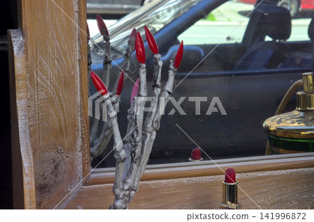 Creative Window Display with Skeleton Hand and Red Lipstick for Unique Retail Design Creative Window Display with Skeleton Hand and Red Lipstick for Unique Retail Design 141996872