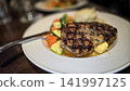 Grilled Ribeye Steak with Herb Butter, Mashed Potatoes and Roasted Vegetables on Plate 141997125