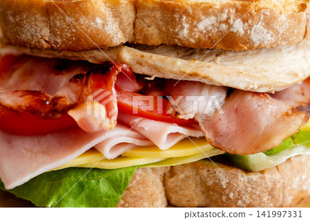 Grilled club sandwich with bacon and ham 141997331